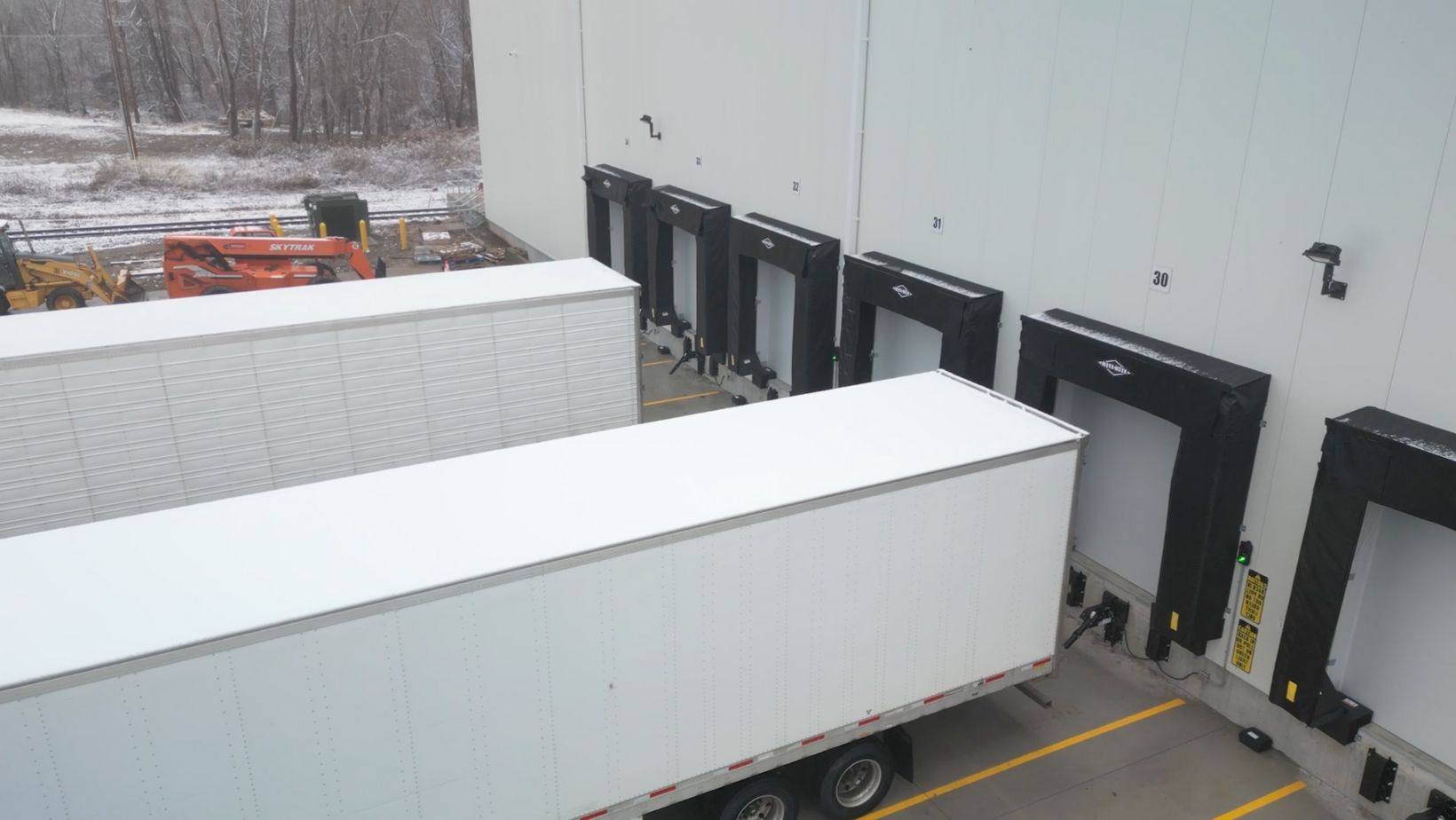 Photo of trucks pulling up to a cold storage warehouse